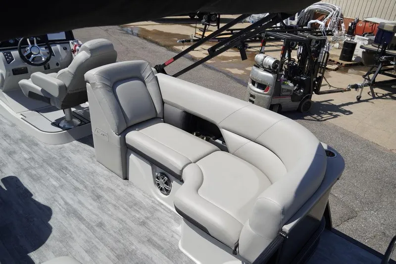 Slide: The Image of 2024 Crest Caribbean LX 250 SLC pontoon boat interior with plush seating. - 10