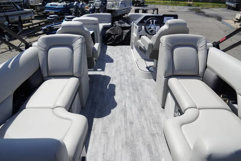 Slide: The Image of 2024 Crest Caribbean LX 250 SLC pontoon boat interior with luxurious seating. - 6