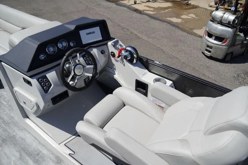 Slide: The Image of 2024 Crest Caribbean LX 250 SLC boat cockpit with steering wheel and control panel. - 7