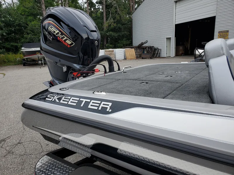 Slide: The Image of 2023 Skeeter ZX200 boat with Yamaha motor, parked near a garage. - 3