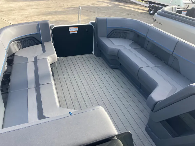 Slide: The Image of 2024 Manitou 24 EXPLORE SWITCHBACK boat interior with spacious seating and modern design. - 11