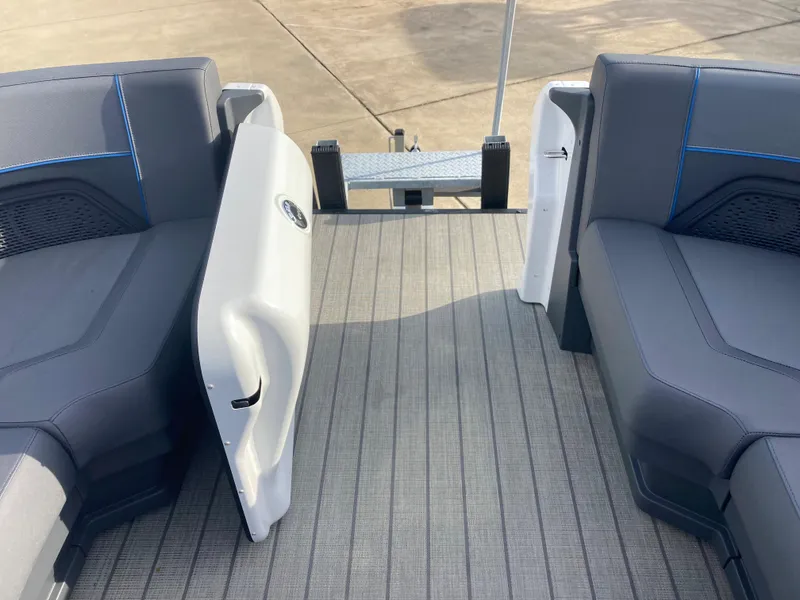 Slide: The Image of 2024 Manitou 24 EXPLORE SWITCHBACK boat interior with open rear gate and seating. - 14