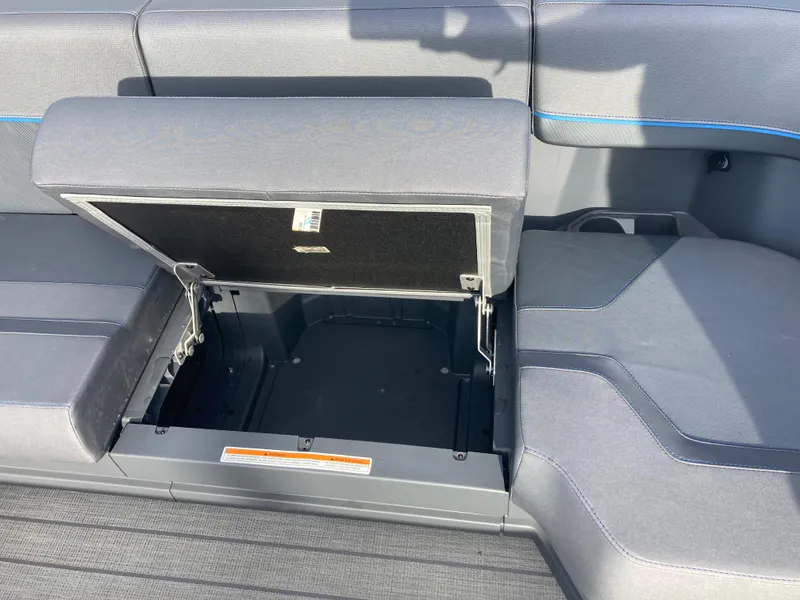 Slide: The Image of 2024 Manitou 24 EXPLORE SWITCHBACK boat with open storage compartment. - 15