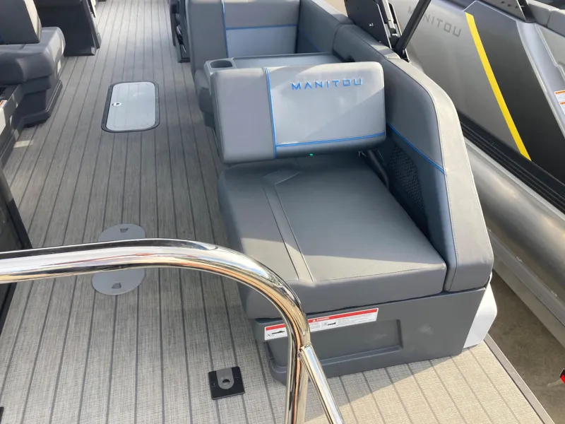 Slide: The Image of 2024 Manitou 24 EXPLORE SWITCHBACK boat interior with gray seating and deck. - 22