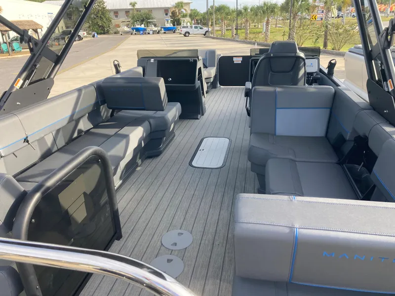 Slide: The Image of 2024 Manitou 24 EXPLORE SWITCHBACK pontoon boat interior with spacious seating and modern design. - 4