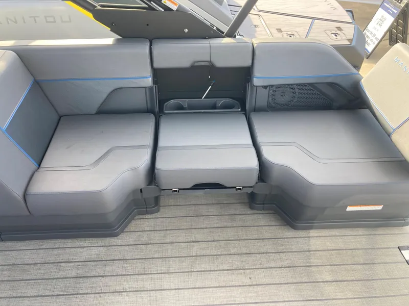 Slide: The Image of 2024 Manitou 24 EXPLORE SWITCHBACK boat interior seating with gray upholstery. - 5