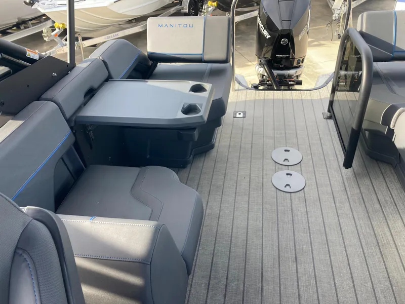 Slide: The Image of 2024 Manitou 24 EXPLORE SWITCHBACK boat interior with seating and table. - 8