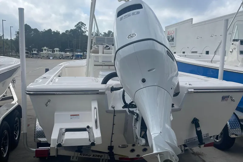 Slide: The Image of 2024 Sea Born FX21 boat with outboard motor, rear view in marina. - 3