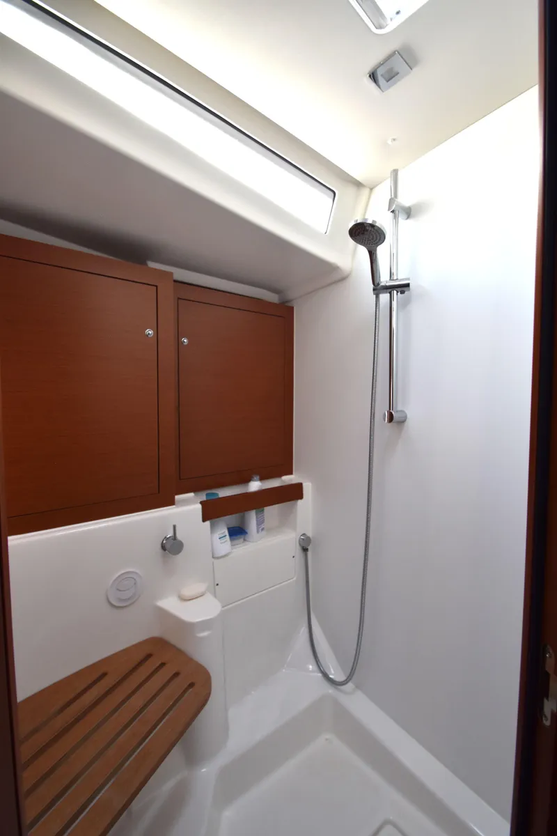 Slide: The Image of 2019 Beneteau 51.1 yacht bathroom with shower and wooden bench. - 11