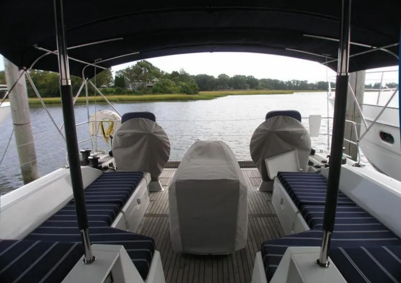 Slide: The Image of 2019 Beneteau 51.1 yacht cockpit with covered seating and scenic water view. - 23