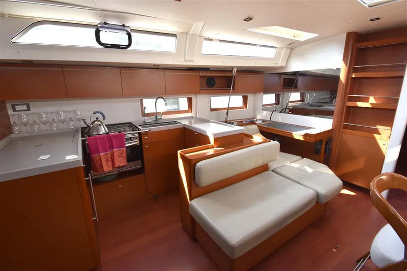 Slide: The Image of Modern interior of 2019 Beneteau 51.1 yacht with kitchen and seating area. - 5