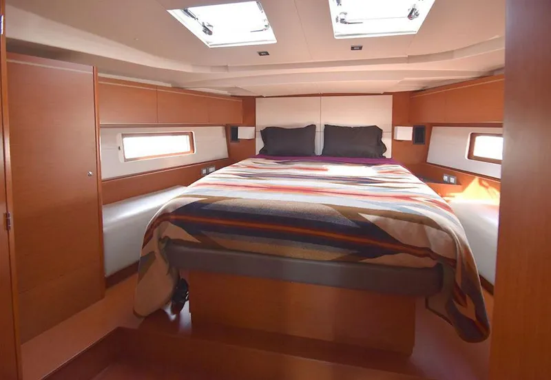 Slide: The Image of Luxurious cabin interior of 2019 Beneteau 51.1 yacht with cozy bedding and natural light. - 8