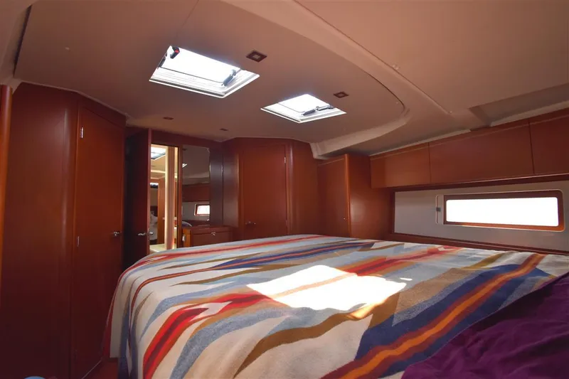 Slide: The Image of Luxurious interior of 2019 Beneteau 51.1 yacht with skylights and colorful bedding. - 9