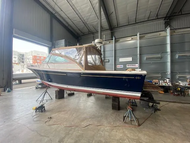Slide: The Image of 2009 Hunt Yachts Harrier 29 in a boatyard, elevated on stands for maintenance. - 12
