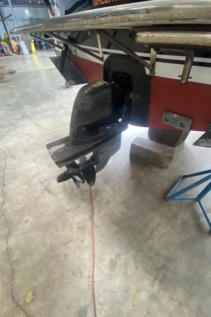 Slide: The Image of 2009 Hunt Yachts Harrier 29 boat stern and outboard motor in a garage. - 13