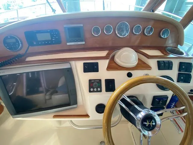 Slide: The Image of 2009 Hunt Yachts Harrier 29 helm with Garmin navigation and wooden steering wheel. - 2
