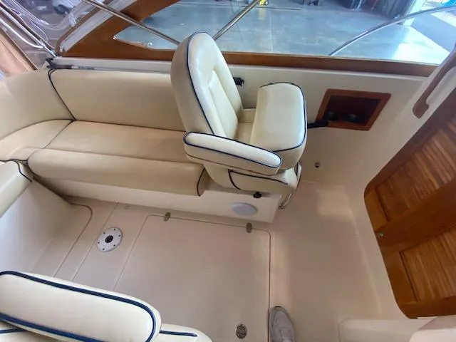 Slide: The Image of 2009 Hunt Yachts Harrier 29 interior with beige seating and blue trim. - 4
