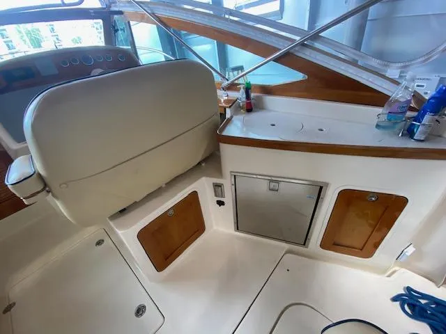 Slide: The Image of 2009 Hunt Yachts Harrier 29 helm with cream leather seating and wooden steering wheel. - 6