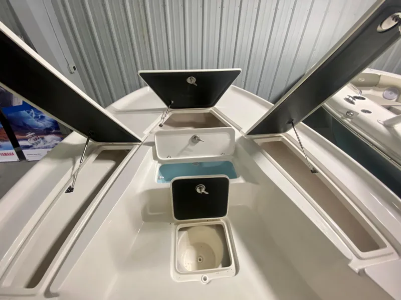 Slide: The Image of 2024 Key West 230 Bay Reef boat storage compartments and livewell. - 22