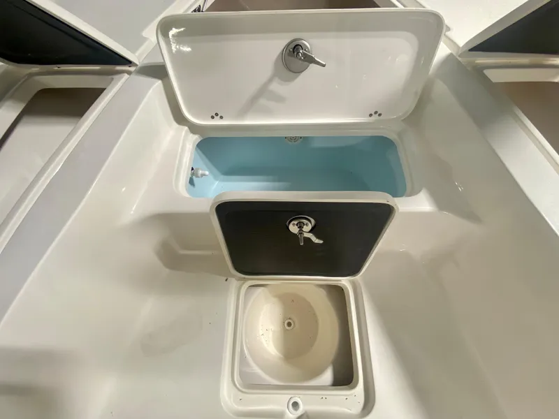 Slide: The Image of 2024 Key West 230 Bay Reef boat storage compartments and livewell. - 23