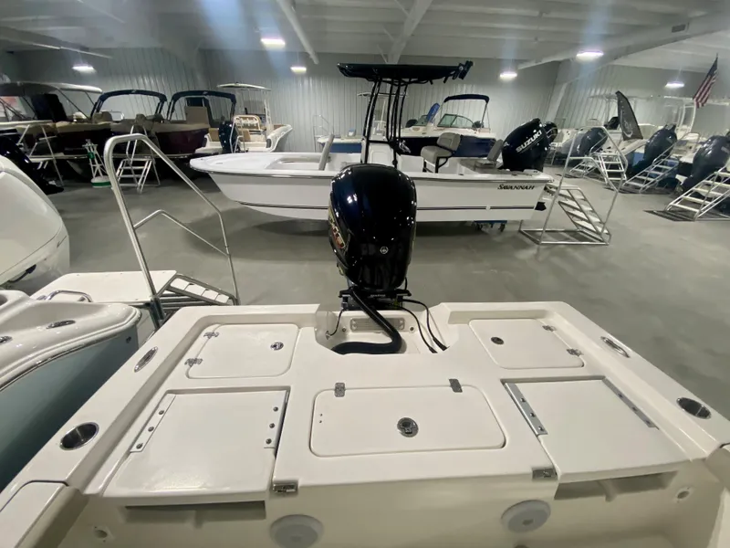 Slide: The Image of 2024 Key West 230 Bay Reef boat in showroom, rear view with outboard motor. - 5