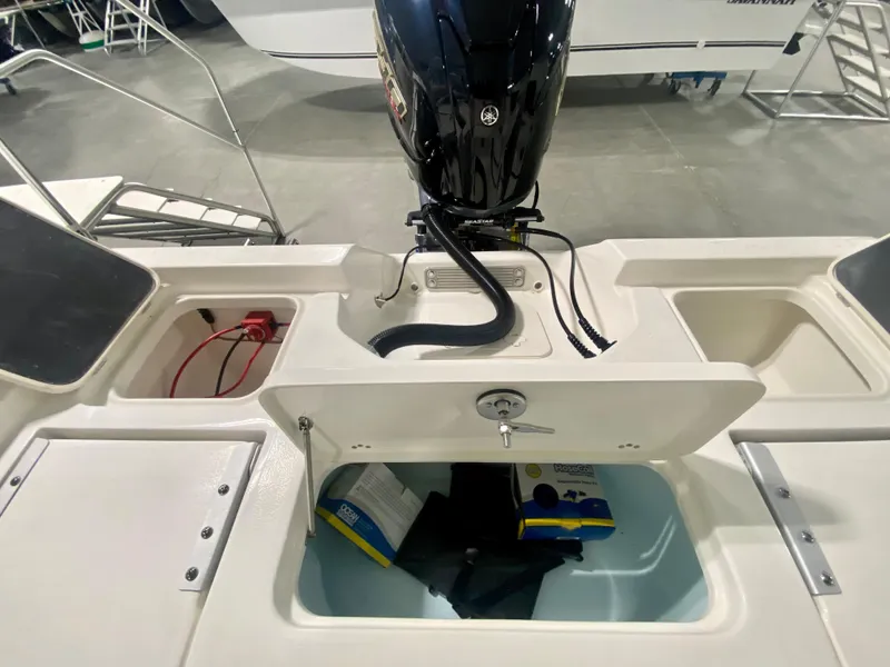 Slide: The Image of 2024 Key West 230 Bay Reef boat stern with storage compartments and outboard motor. - 9