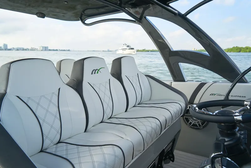 Slide: The Image of Luxurious seating on a 2021 Midnight Express 43' Open boat with scenic water view. - 17
