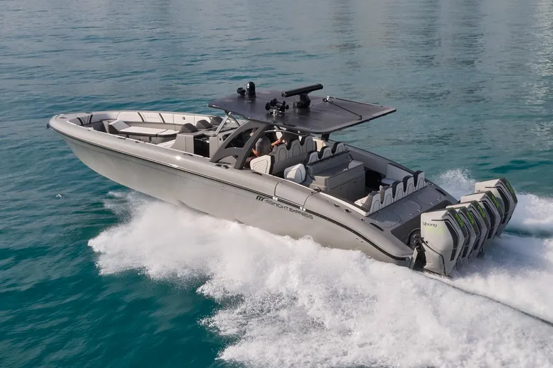Slide: The Image of 2021 Midnight Express 43' Open boat cruising on water with multiple outboard engines. - 4