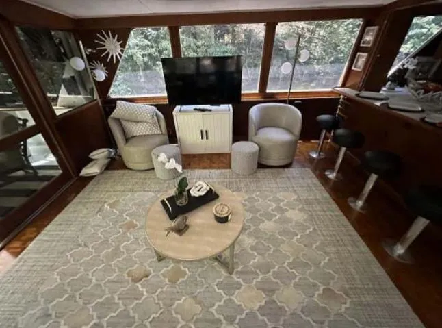 Slide: The Image of 1976 Chris-Craft Roamer yacht interior with modern seating, TV, and stylish decor. - 11