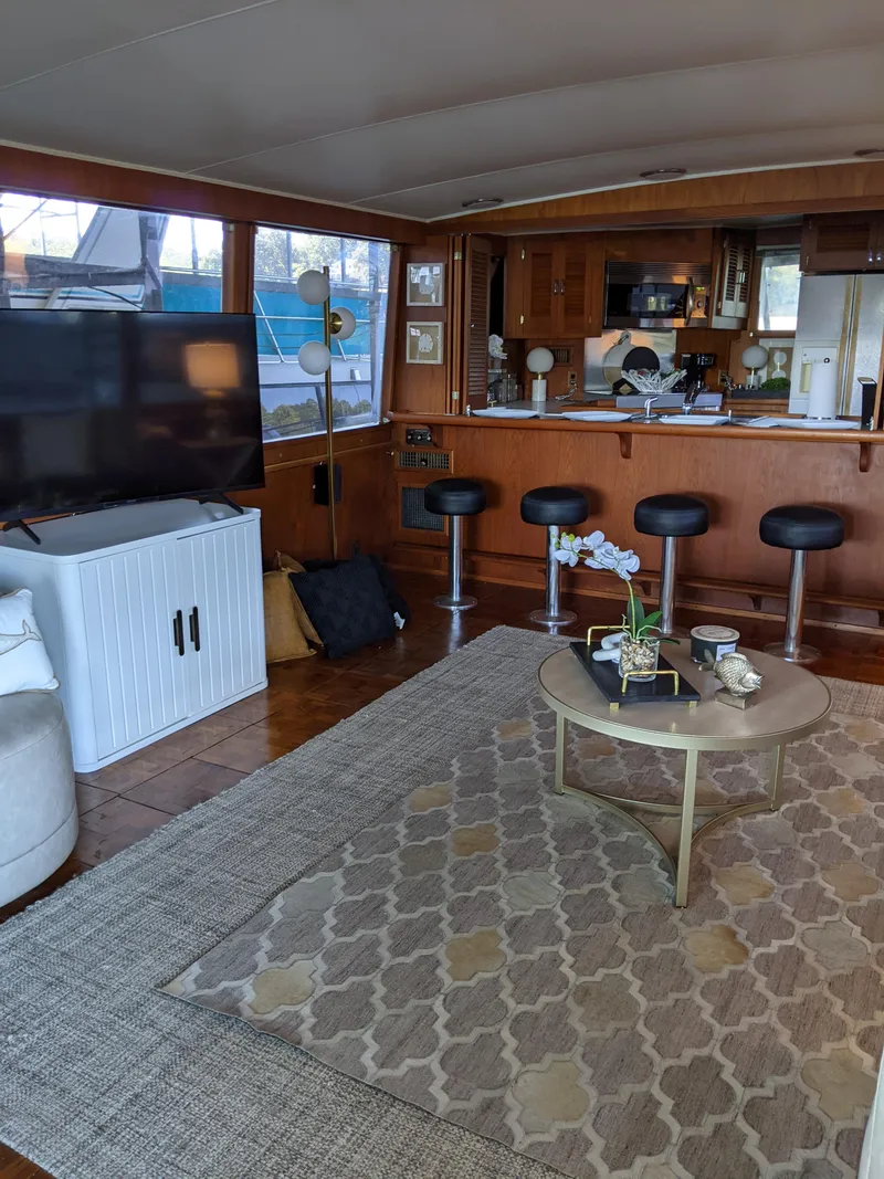 Slide: The Image of 1976 Chris-Craft Roamer yacht interior with modern living area and kitchen. - 15
