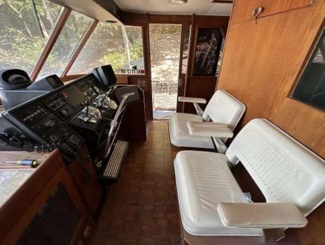 Slide: The Image of 1976 Chris-Craft Roamer interior with white seating and control panel. - 18