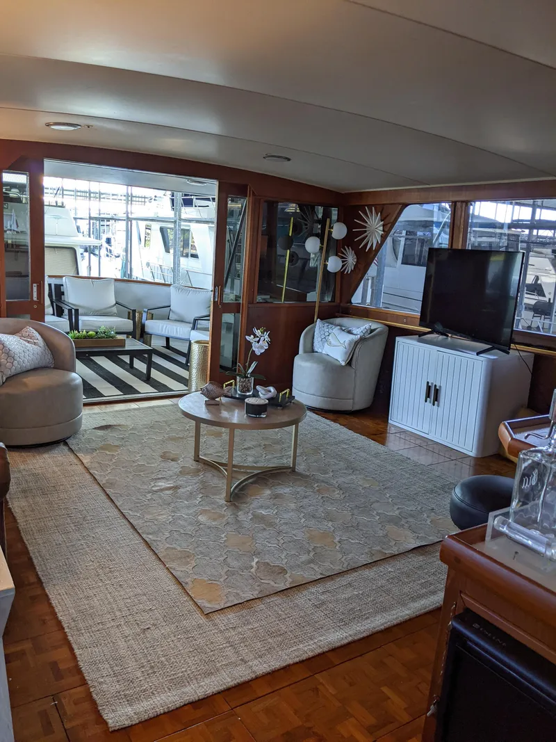 Slide: The Image of 1976 Chris-Craft Roamer yacht interior with modern living area and large windows. - 19