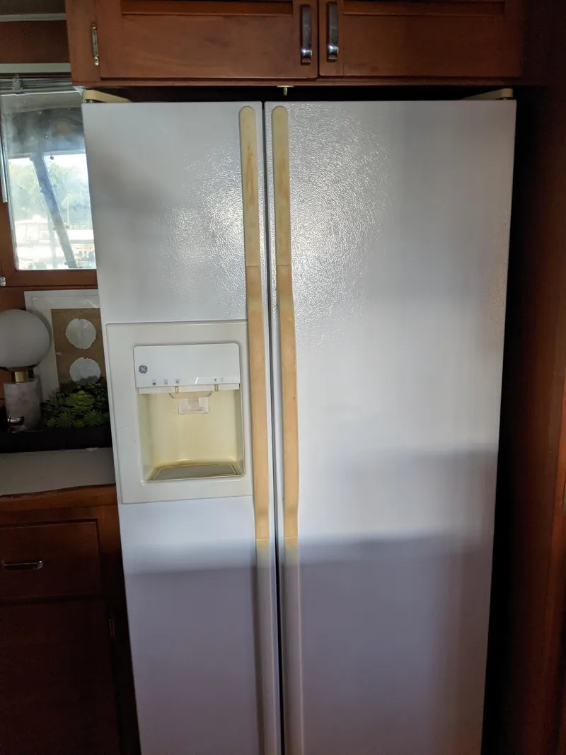 Slide: The Image of 1976 Chris-Craft Roamer kitchen with a white side-by-side refrigerator. - 24