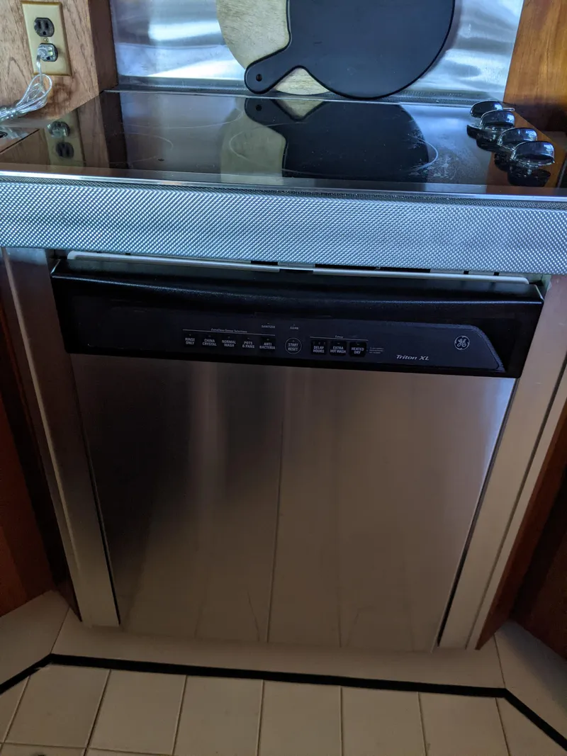 Slide: The Image of Stainless steel dishwasher in a 1976 Chris-Craft Roamer yacht kitchen. - 25