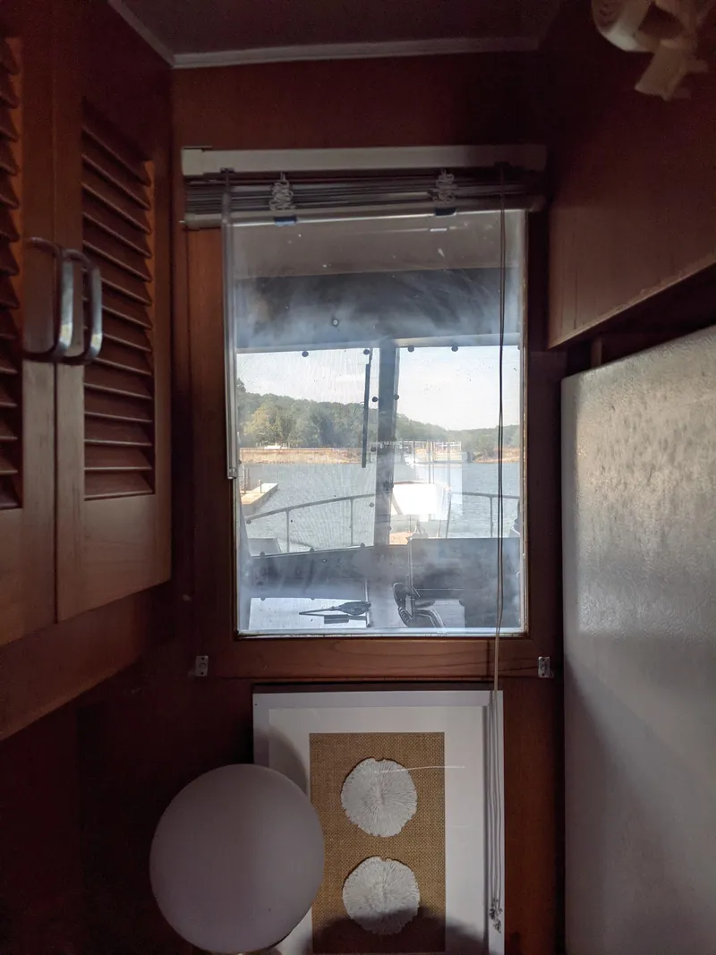 Slide: The Image of Interior view of 1976 Chris-Craft Roamer with window overlooking water. - 27