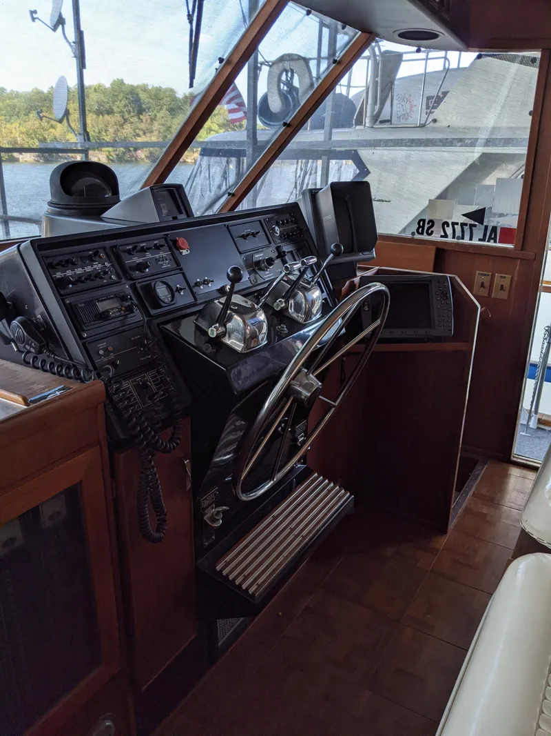 Slide: The Image of 1976 Chris-Craft Roamer boat cockpit with steering wheel and control panel. - 30