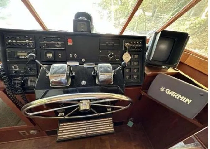 Slide: The Image of 1976 Chris-Craft Roamer helm with Garmin navigation system and classic control panel. - 31