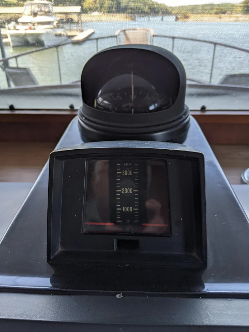Slide: The Image of 1976 Chris-Craft Roamer boat dashboard with compass and speedometer. - 33