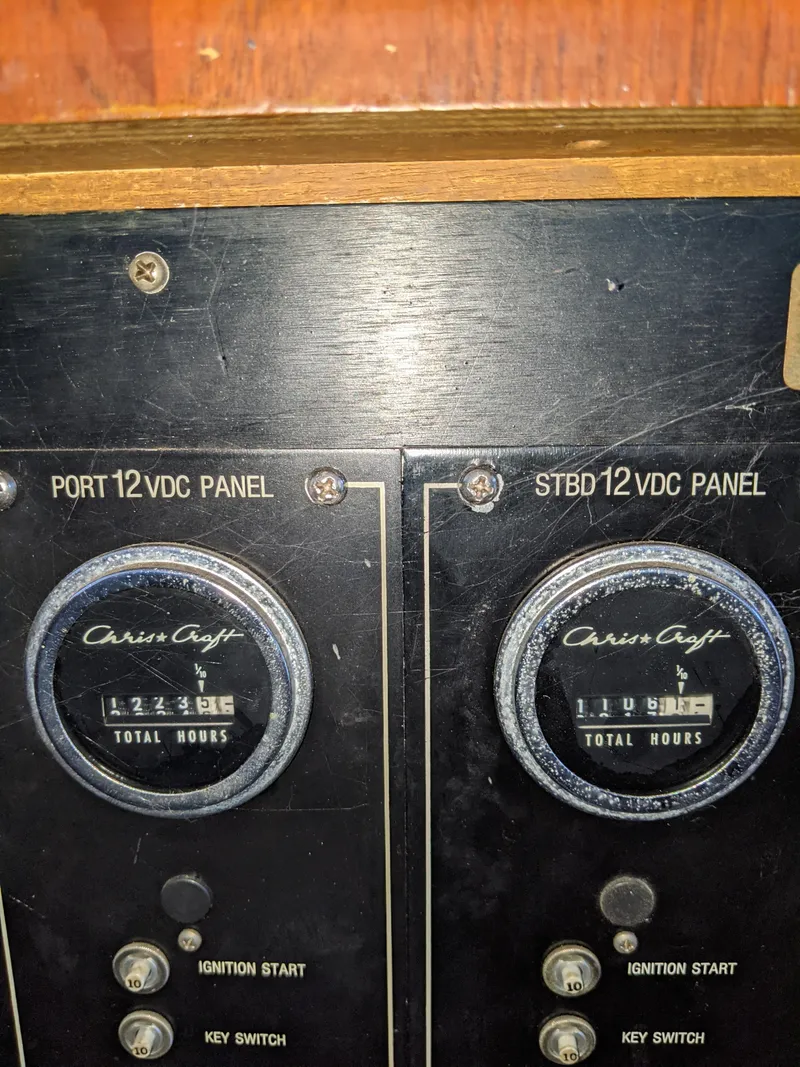 Slide: The Image of 1976 Chris-Craft Roamer control panel with hour meters and ignition switches. - 35