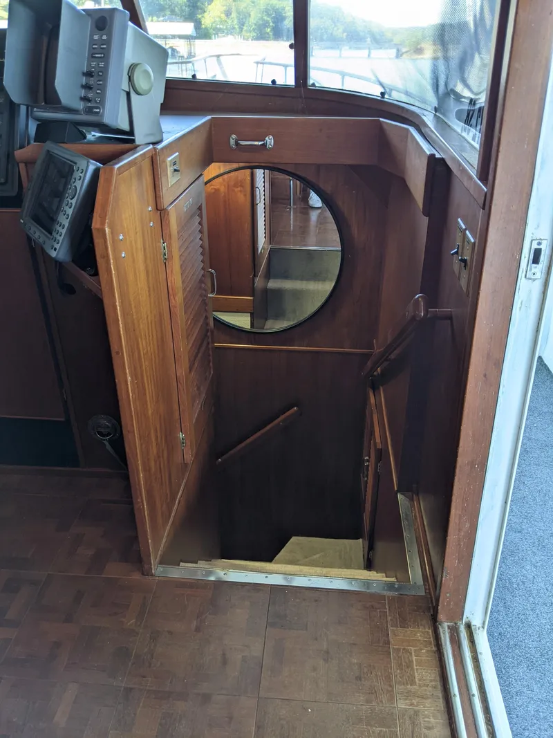 Slide: The Image of 1976 Chris-Craft Roamer interior with wooden stairs leading below deck. - 38