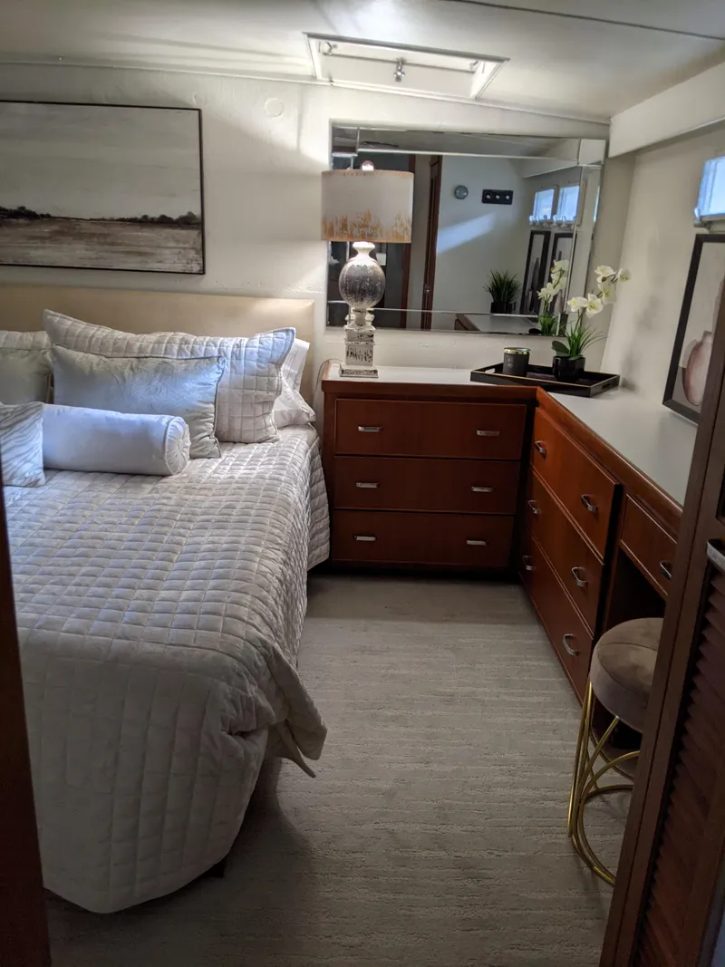 Slide: The Image of 1976 Chris-Craft Roamer bedroom with modern decor and cozy bedding. - 43