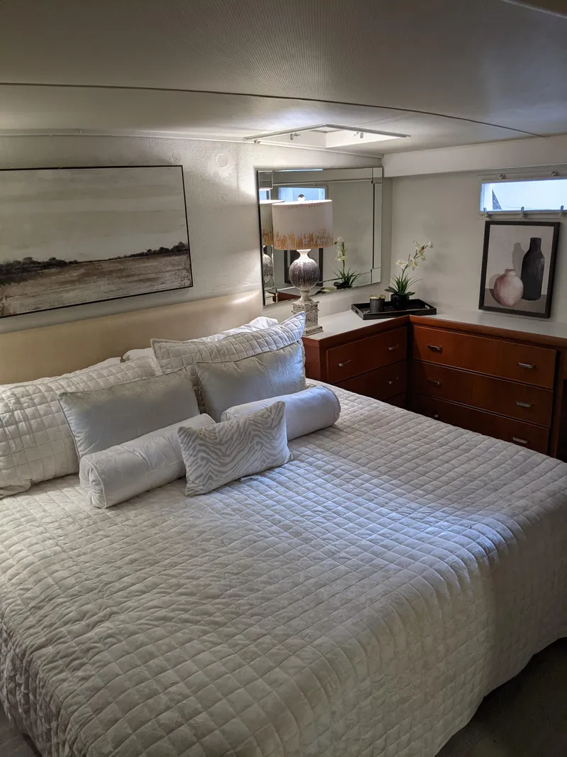 Slide: The Image of Luxurious bedroom interior of a 1976 Chris-Craft Roamer yacht with elegant decor. - 44