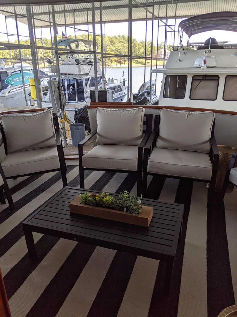 Slide: The Image of 1976 Chris-Craft Roamer yacht with outdoor seating area and striped rug. - 5