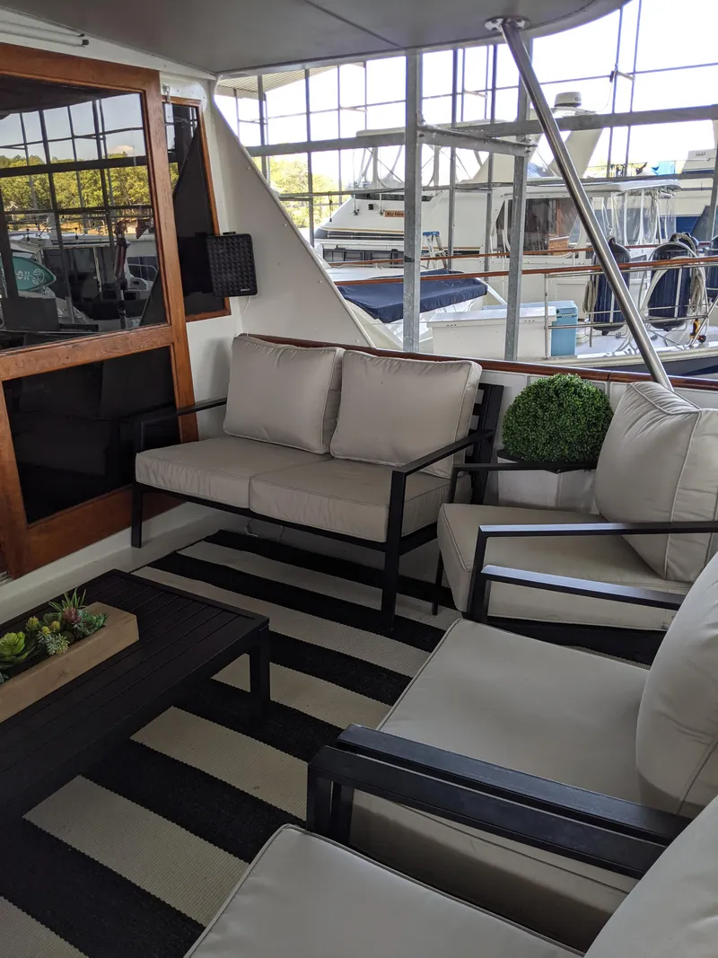 Slide: The Image of 1976 Chris-Craft Roamer yacht interior with modern seating and striped rug. - 7