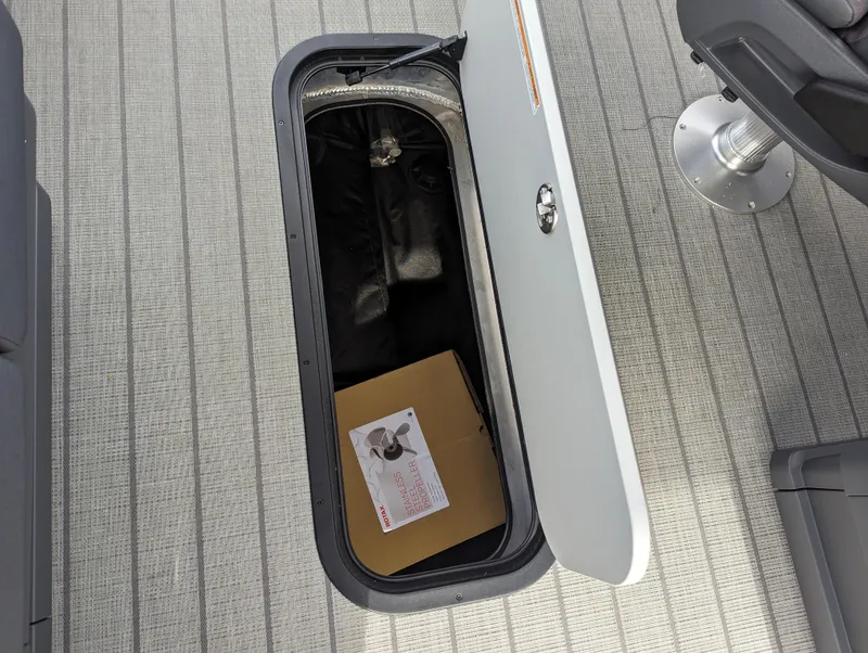 Slide: The Image of 2024 Manitou Explore 22 MAX w/150 Rotax storage compartment with a box inside. - 12