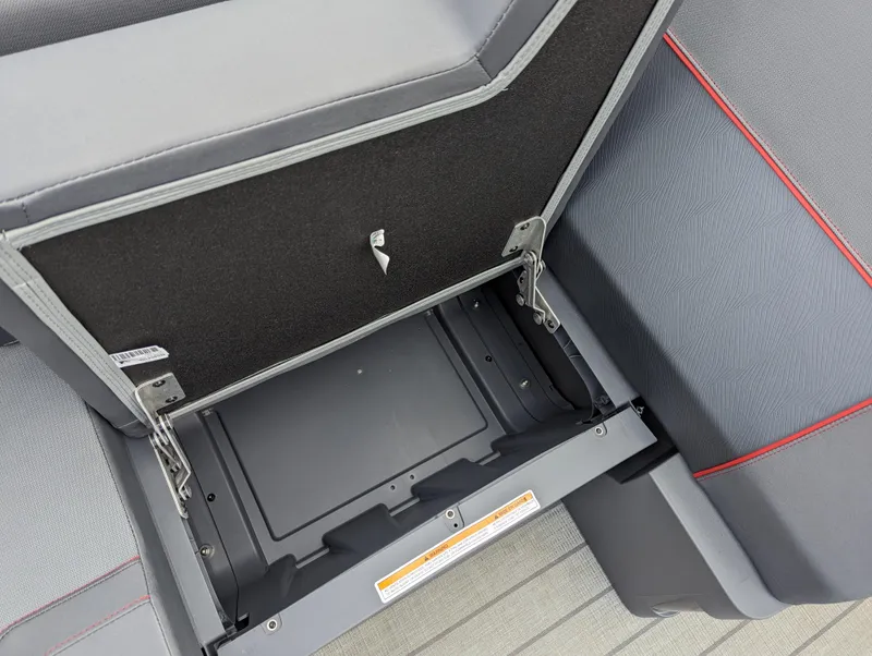 Slide: The Image of Open storage compartment in 2024 Manitou Explore 22 MAX w/150 Rotax boat. - 13