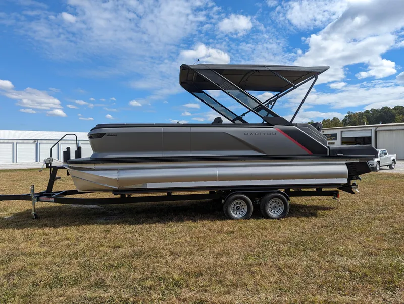 Slide: The Image of 2024 Manitou Explore 22 MAX pontoon boat with 150 Rotax engine on trailer. - 3