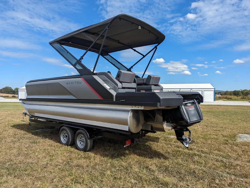 Slide: The Image of 2024 Manitou Explore 22 MAX pontoon boat with 150 Rotax engine on trailer. - 5