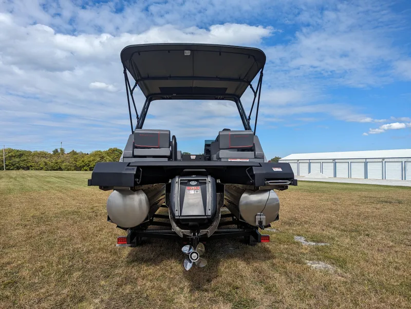 Slide: The Image of 2024 Manitou Explore 22 MAX pontoon boat with 150 Rotax engine, rear view. - 6