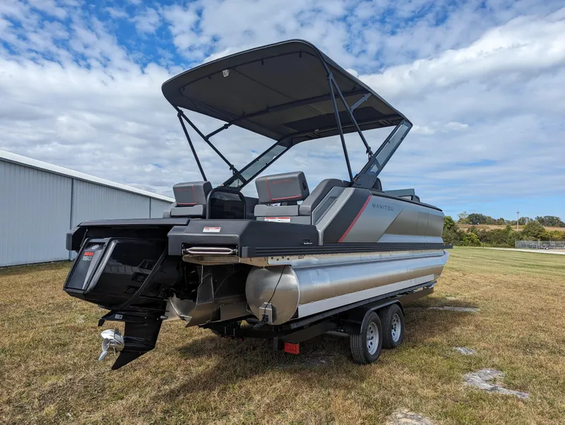 Slide: The Image of 2024 Manitou Explore 22 MAX pontoon boat with 150 Rotax engine on trailer. - 7